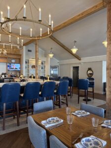 a dining room with blue chairs and a wooden table