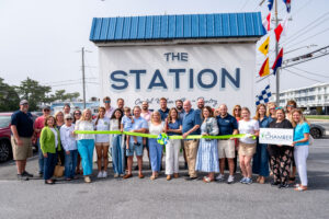 a group of people standing in front of a station