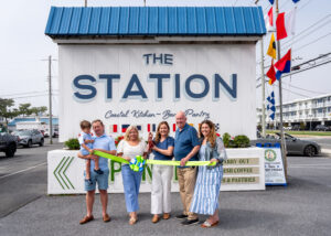a group of people standing in front of a station