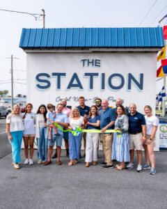 a group of people standing in front of a station