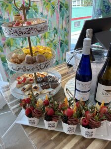 a table topped with plates of food and bottles of wine