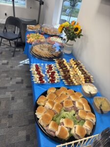 a buffet table filled with sandwiches and dips