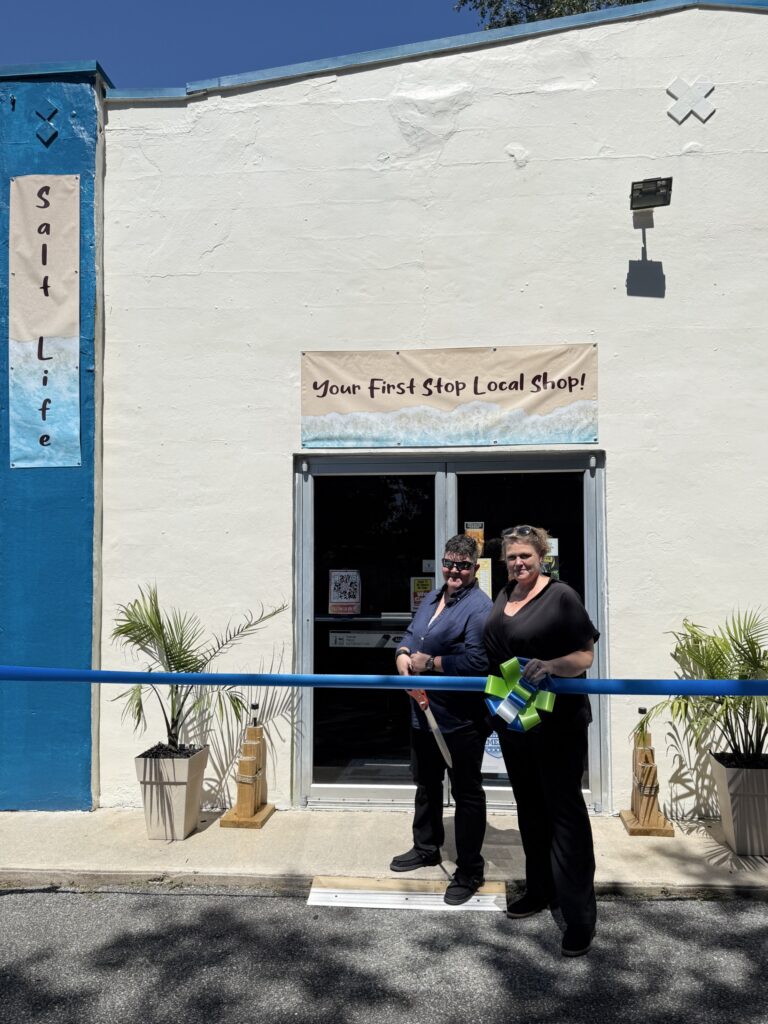 a couple of women standing in front of a building