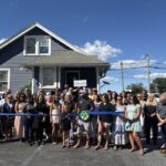 a group of people standing in front of a house