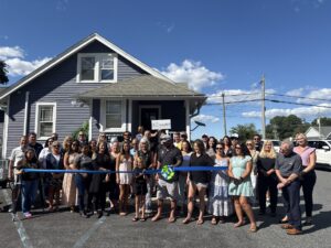a group of people standing in front of a house