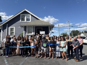 a group of people standing in front of a house