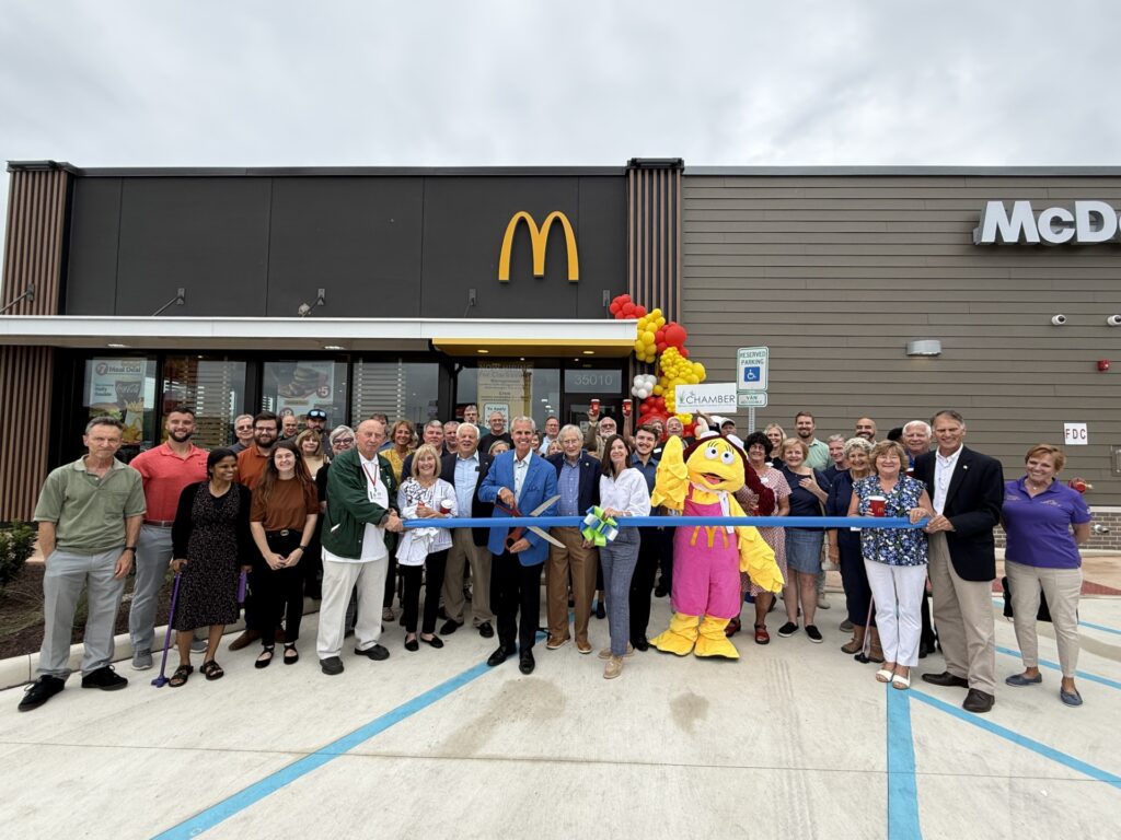 a group of people standing in front of a mcdonalds