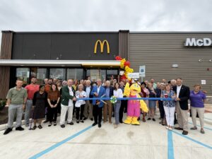 a group of people standing in front of a mcdonalds