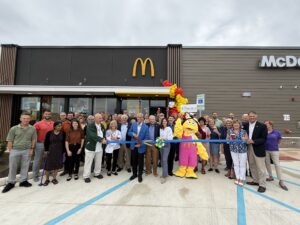 a group of people standing in front of a mcdonald's