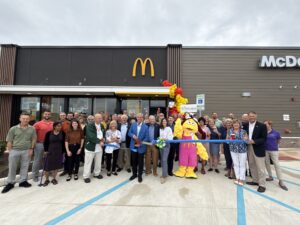 a group of people standing in front of a mcdonald's