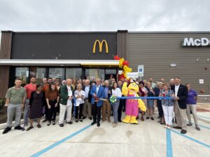 a group of people standing in front of a mcdonald's