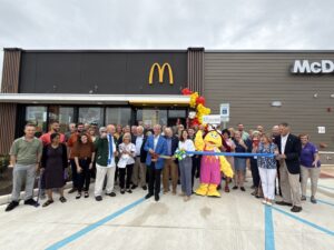 a group of people standing in front of a mcdonald's