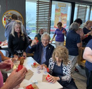 a group of people sitting around a table eating food