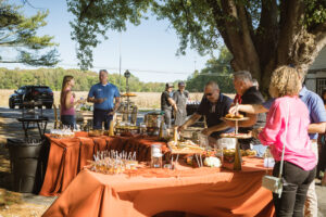 a group of people standing around a table