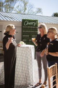 a group of women standing around a table