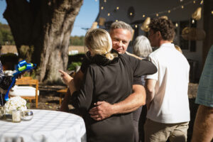 a man and woman hug each other at a party