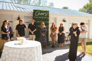 a group of people standing around a table