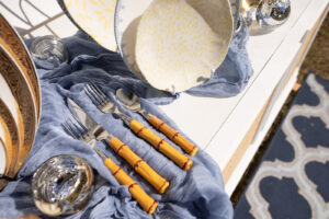 a table topped with plates and silverware on top of a table