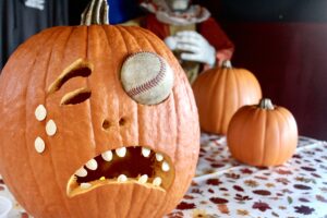 a pumpkin with a baseball inside of it
