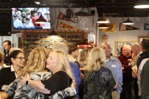 a group of people standing around a bar