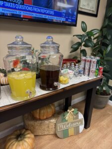a table with drinks and a television in the background