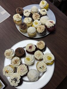 two plates of cupcakes on a table