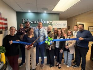 a group of people holding a blue ribbon