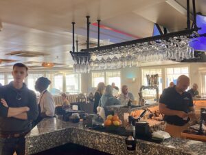 a group of people standing around a bar