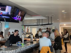 a group of people standing around a bar
