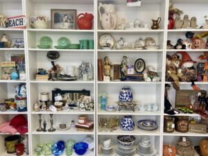 a shelf filled with lots of different types of vases