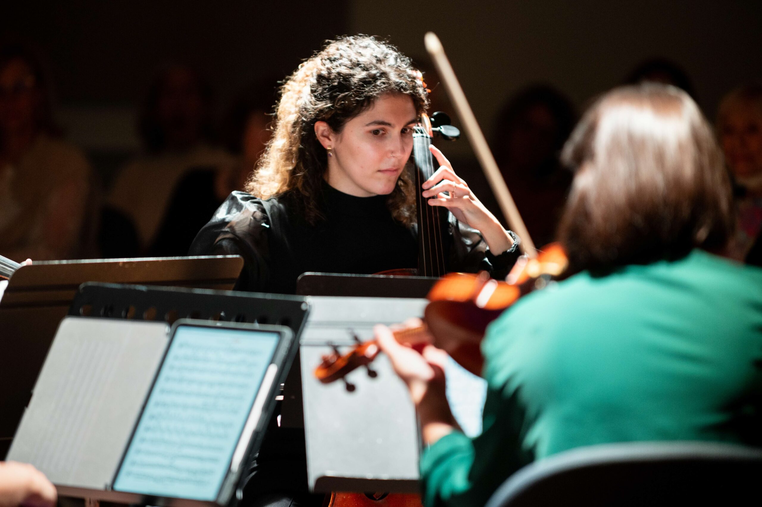 a group of people playing instruments in a room