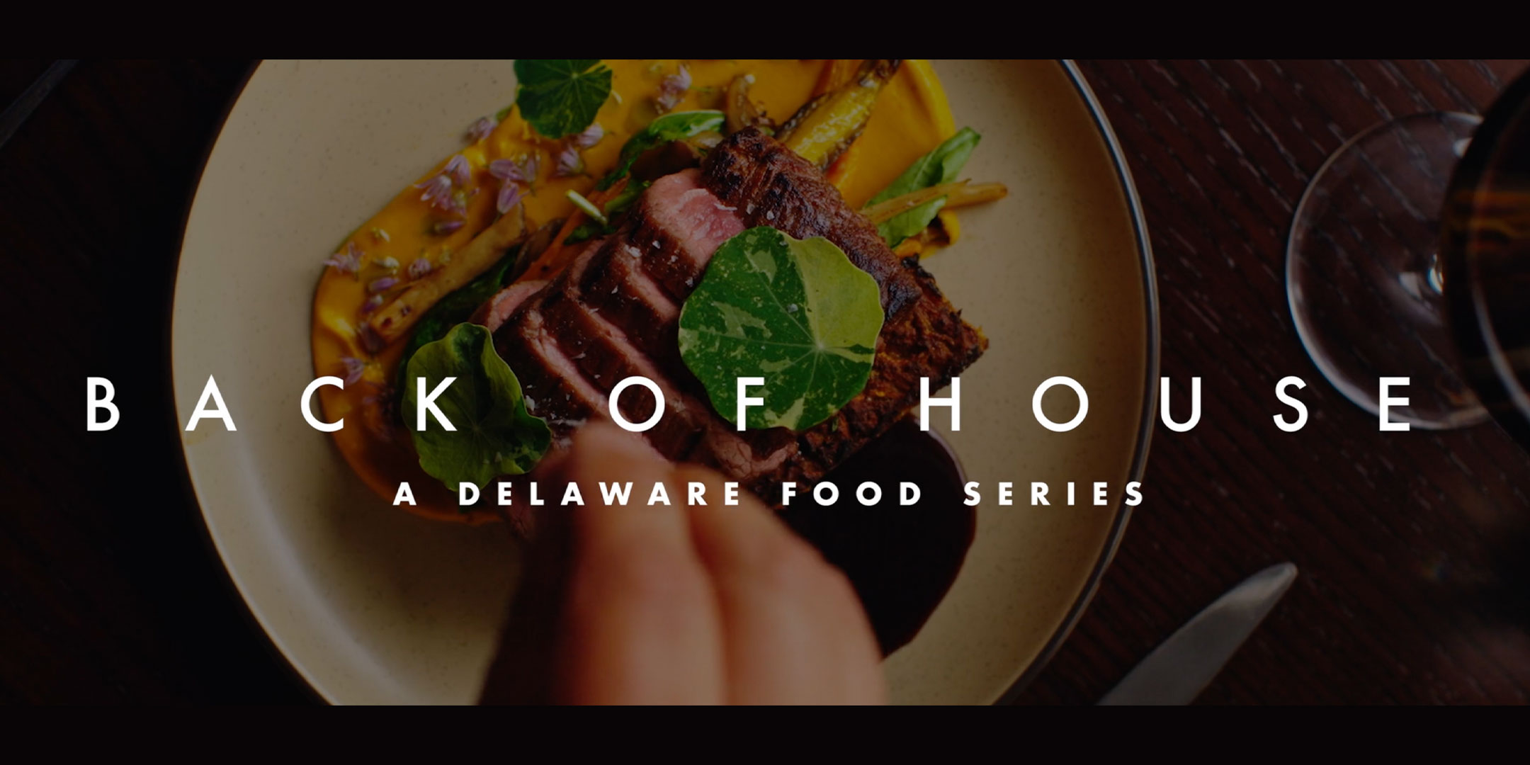 a plate of food with the words back of house on it