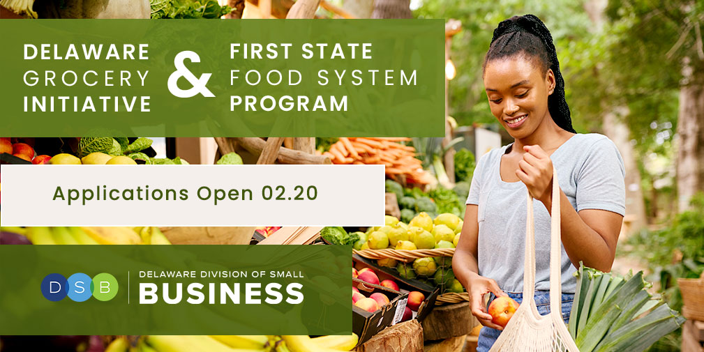a woman standing in front of a fruit stand