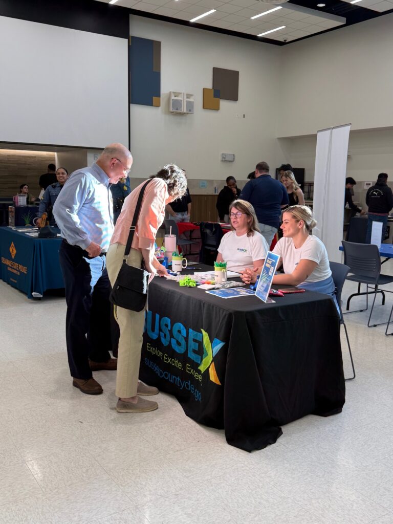 a group of people standing around a table
