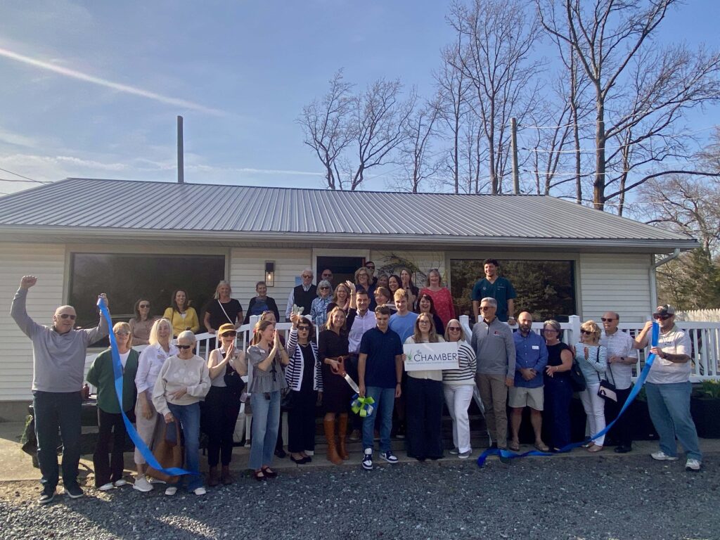 a group of people standing in front of a house