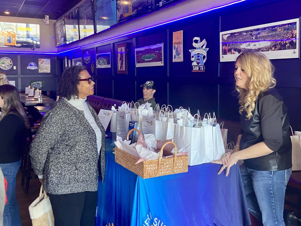 a group of people standing around a table