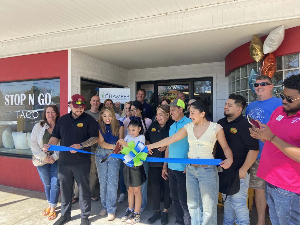 a group of people standing in front of a store