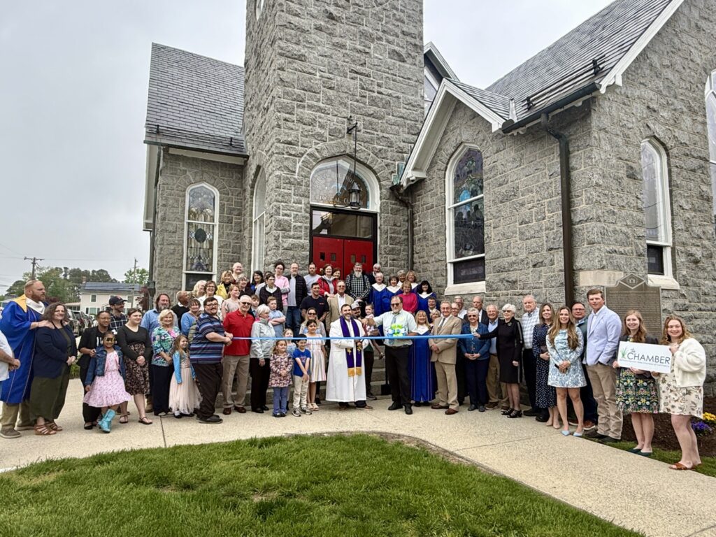a group of people standing in front of a church
