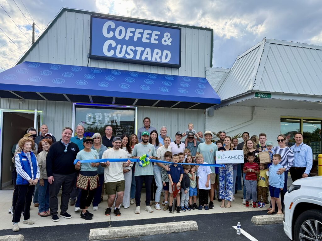 a group of people standing in front of a coffee and custard store