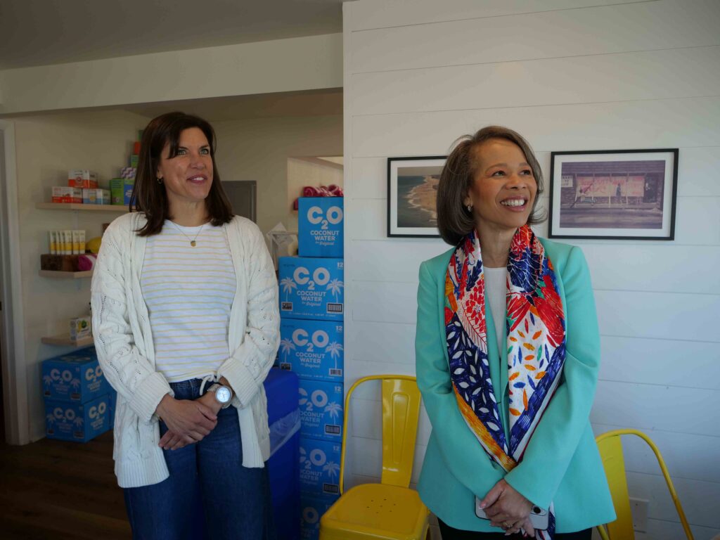two women standing next to each other in a room