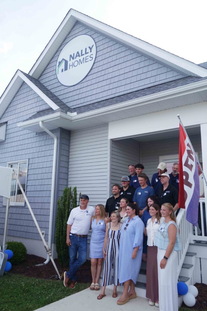 a group of people standing in front of a house