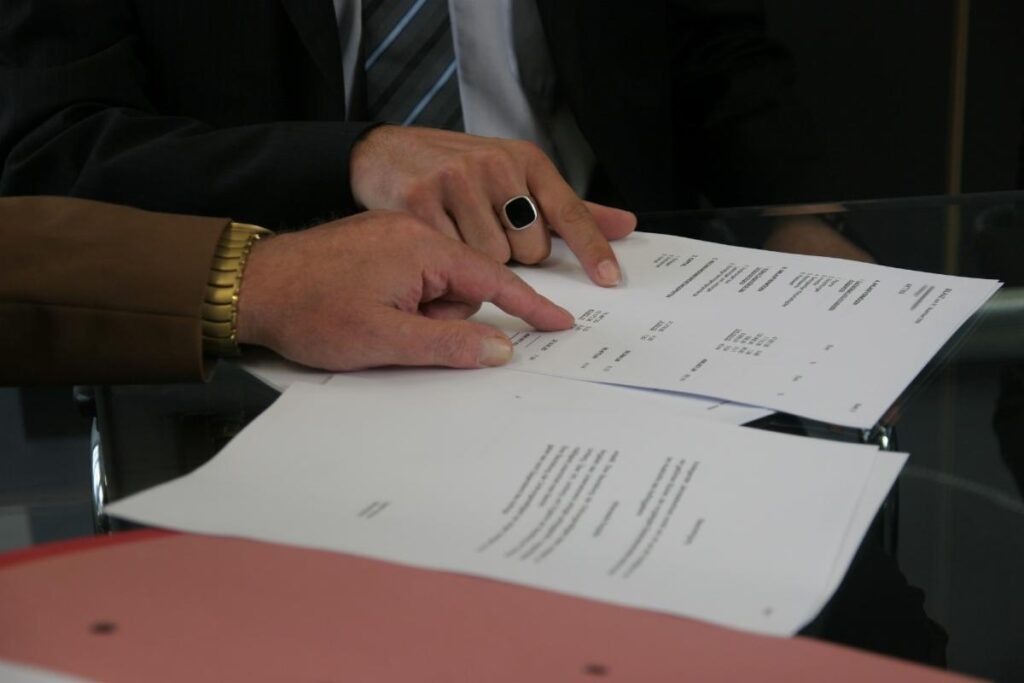 a man in a suit is holding papers