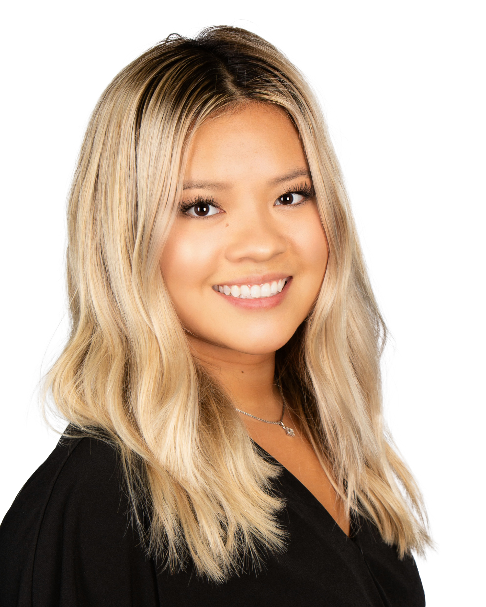 a woman with long blonde hair smiling at the camera