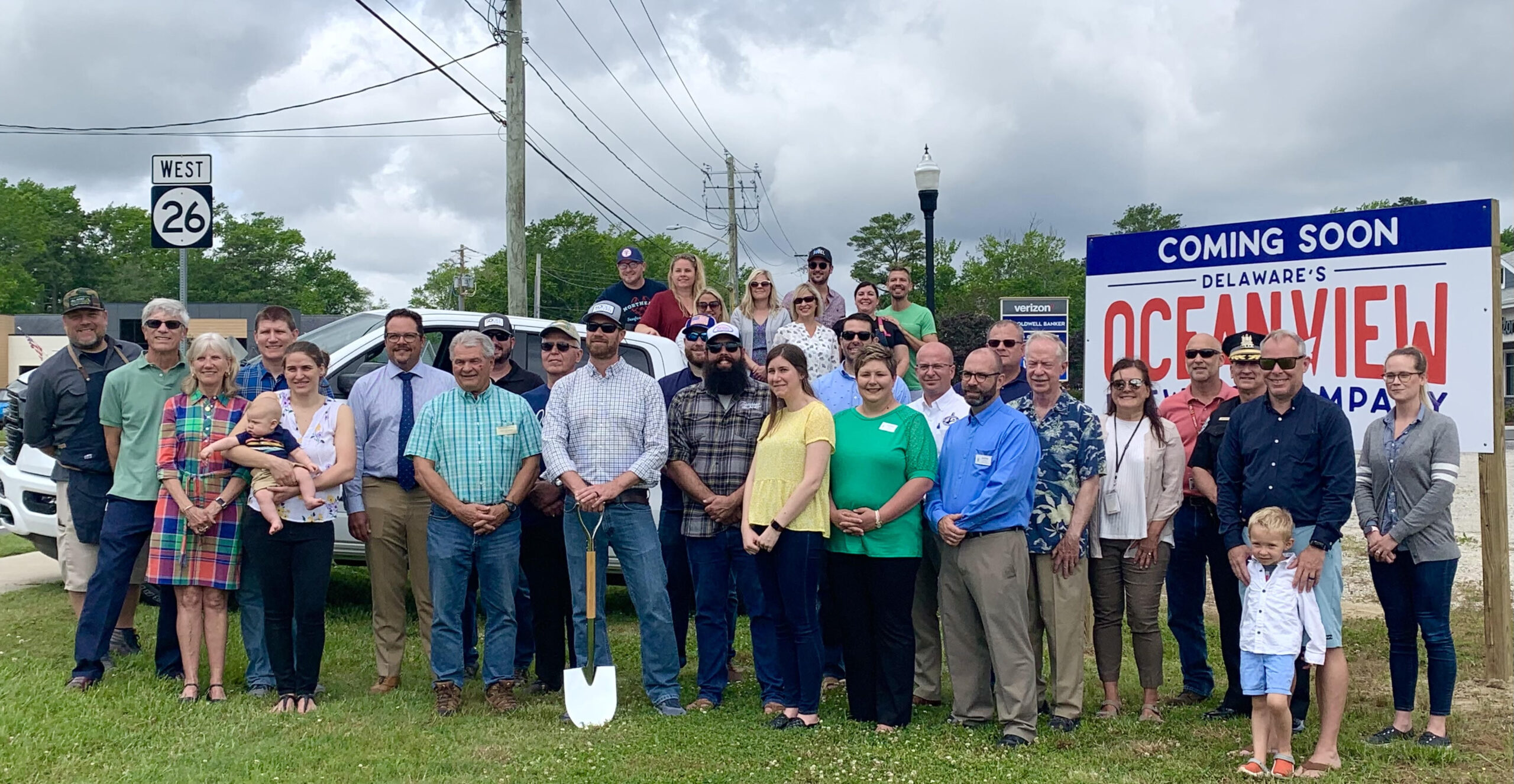a group of people standing in front of a sign