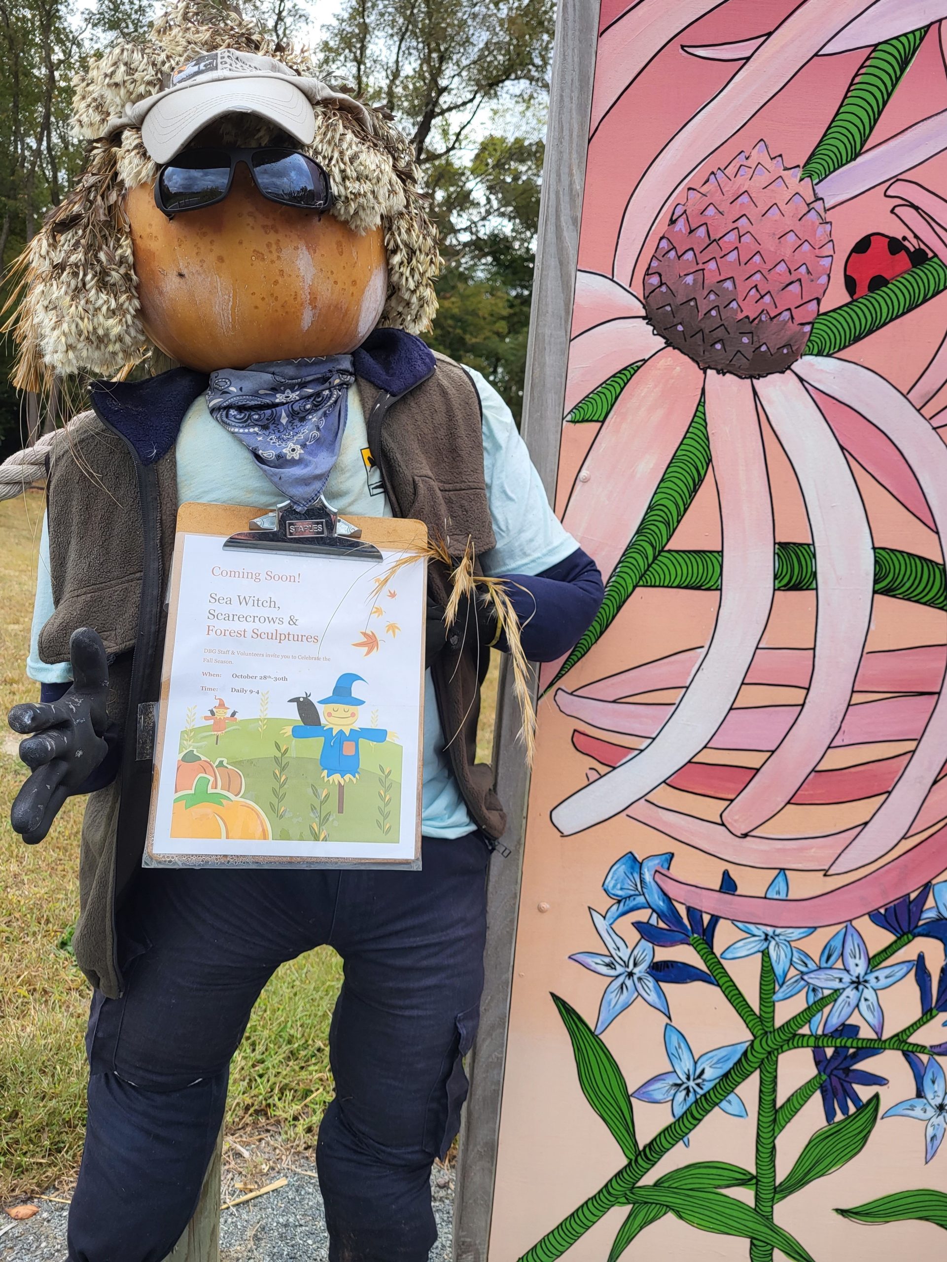 a person wearing a hat and sunglasses holding a plaque
