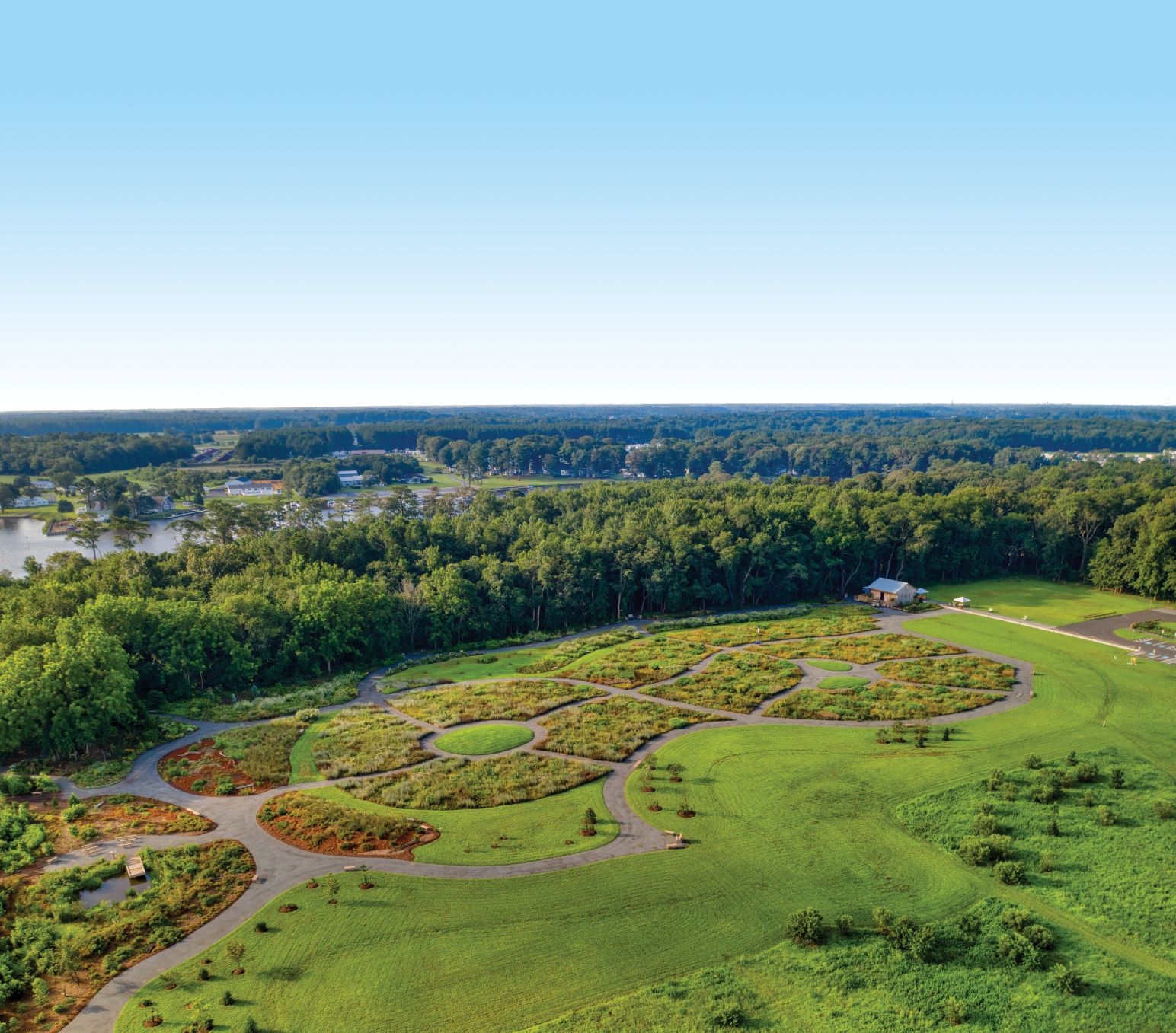an aerial view of a golf course surrounded by trees