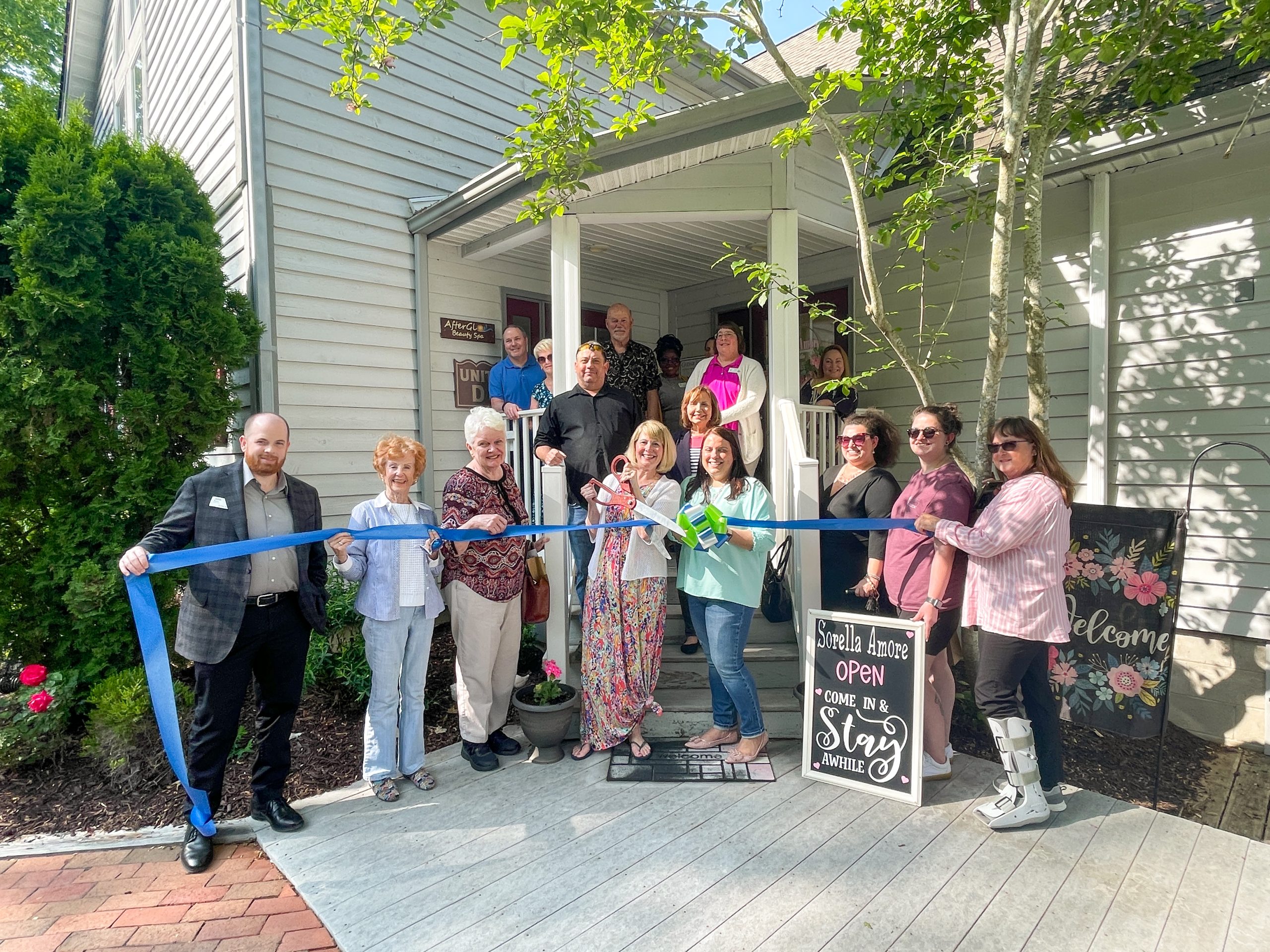 a group of people standing in front of a house