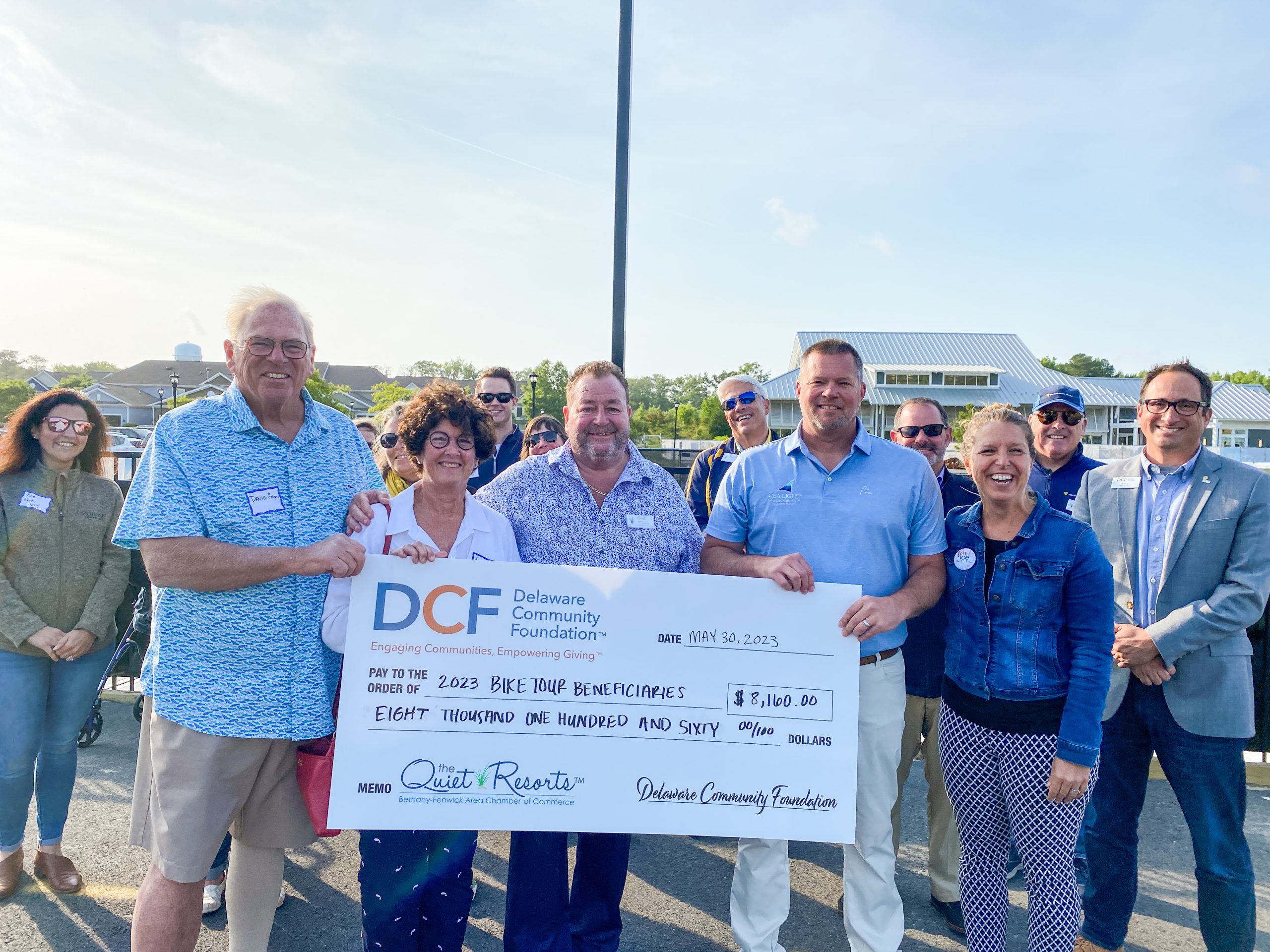 a group of people holding a large check