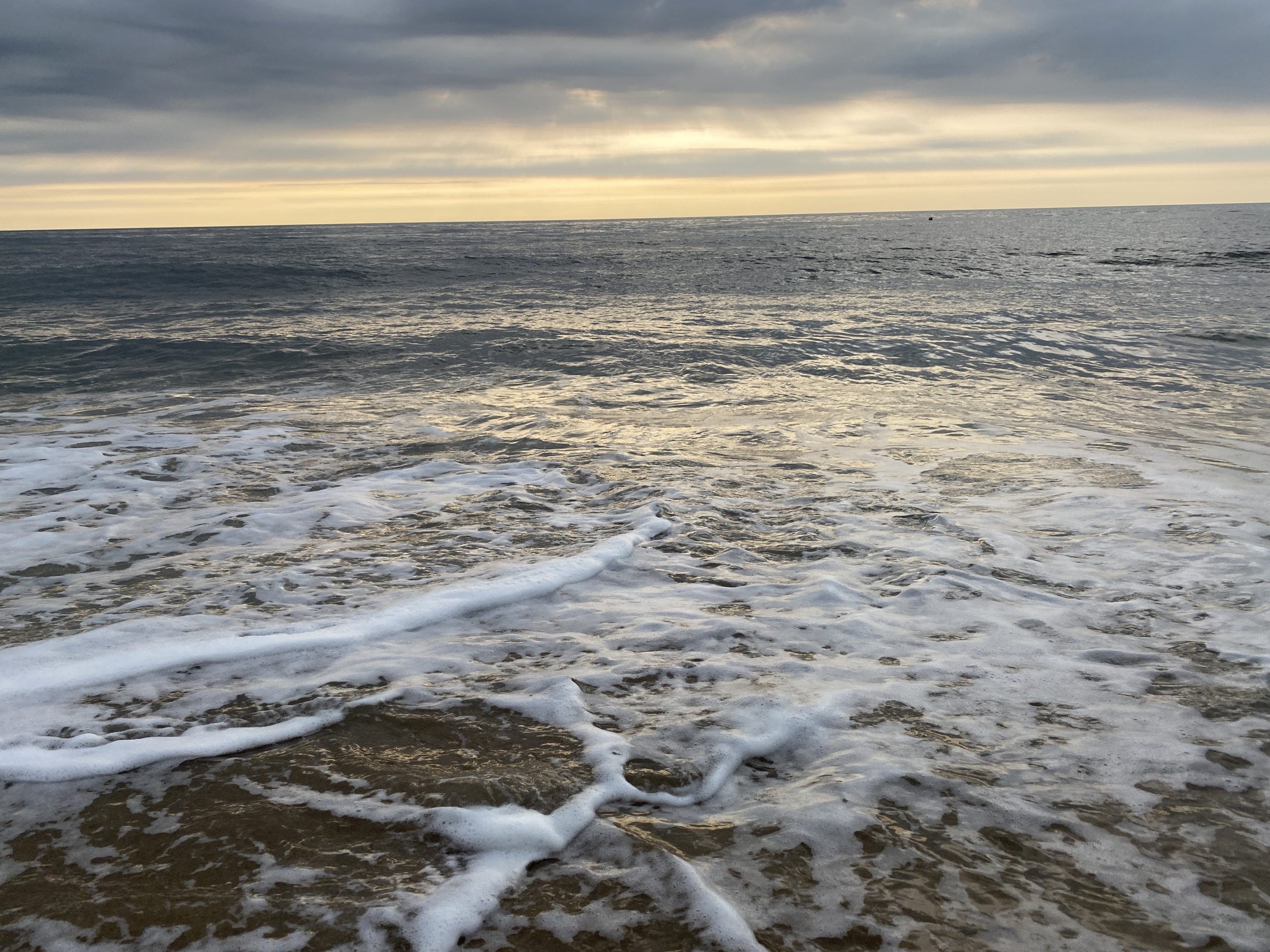 the ocean is covered with foamy waves