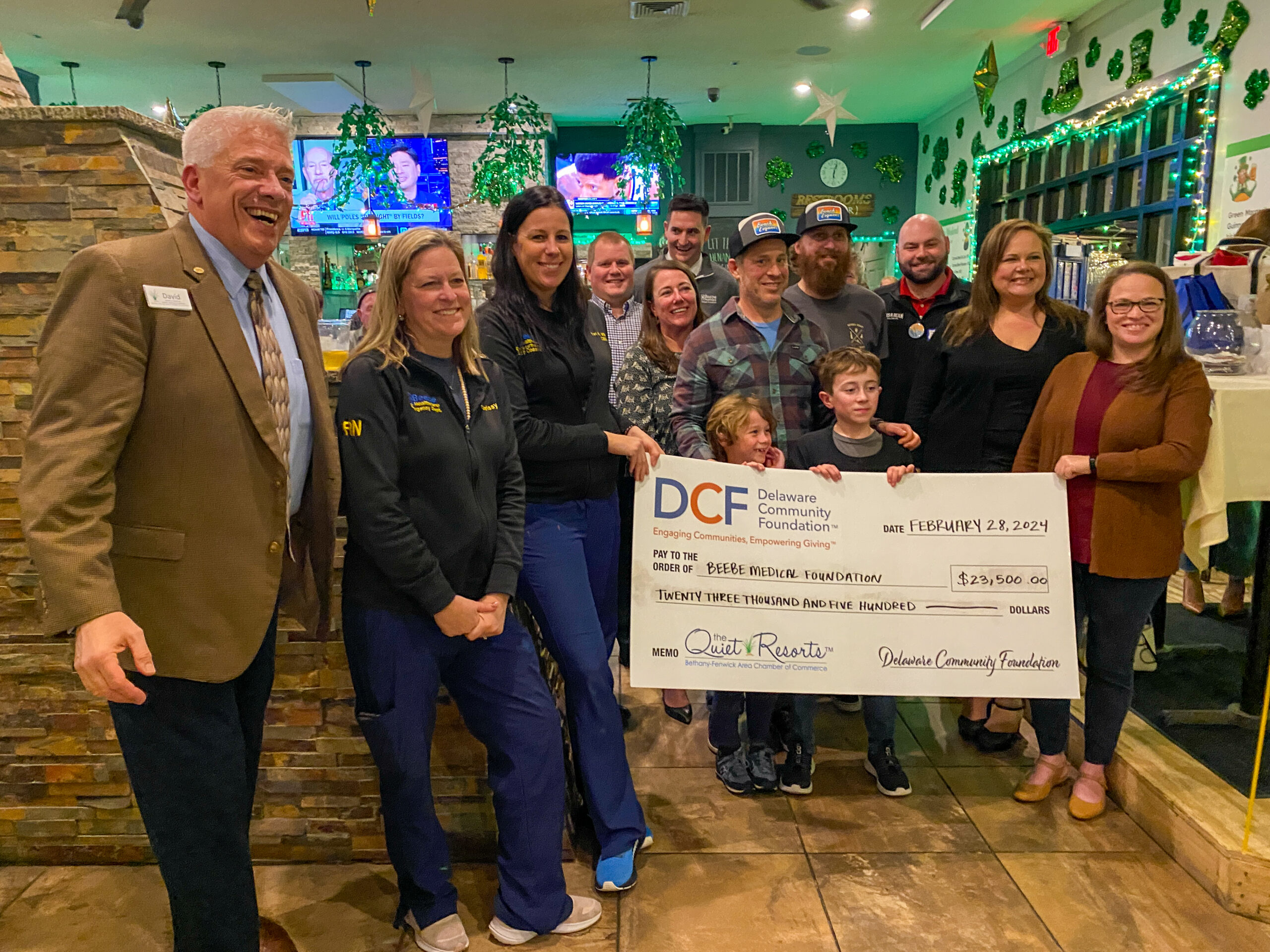 a group of people standing around a large check